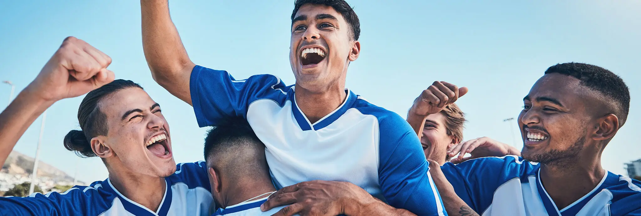 Group picture of high school athletes wearing different jerseys representing various sports.